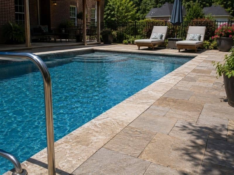 Pool masonry with a stone deck around a residential swimming pool in Alabama