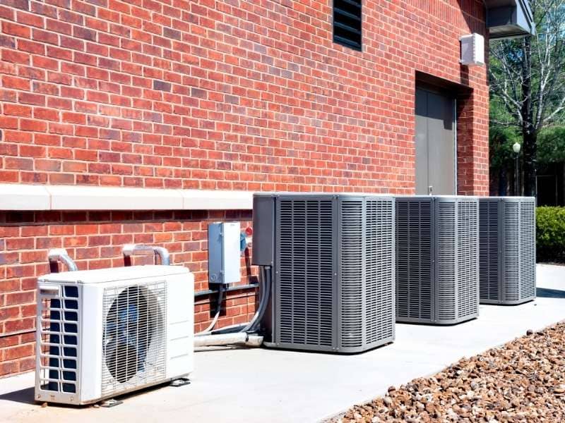 Brickmason built masonry equipment screen around commercial HVAC units with proper airflow and service access in Auburn, Alabama

